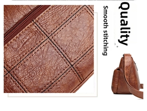 Detail of brown litchi pattern leather with grid stitching and smooth metal zipper