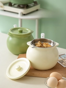Detail of ceramic oil storage jars with fine mesh filters and matching lids in a kitchen