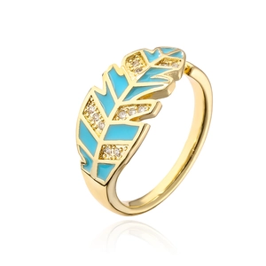 Macro detail of gold-plated leaf ring with blue enamel and micro-set zircon accents