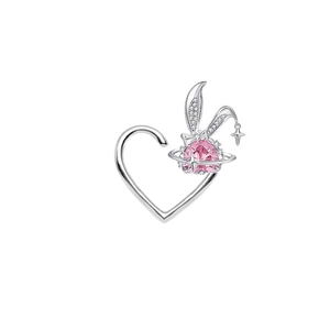Detailed view of silver heart earring with pink gemstone, rabbit ears and star accents