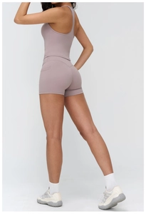Detail of yoga set with high-waist shorts featuring a side pocket and smooth stitching