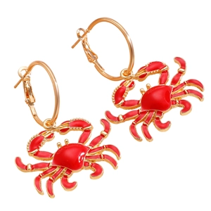 Golden hoop earrings with vibrant red enamel crab pendants in a nautical ocean style