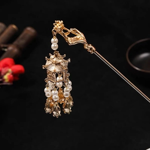 Close-up of golden palace lantern hair stick with pearl tassels on dark background