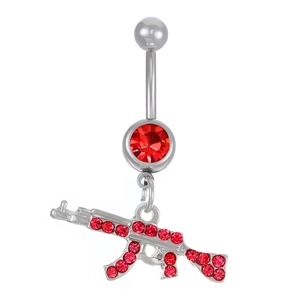 Detailed view of silver belly ring with red zircon and AK-47 rifle shaped pendant