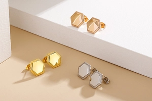 Detailed view of hexagonal stud earrings in rose gold, gold, and silver stainless steel