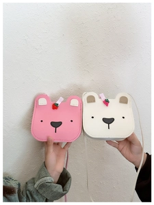 Detail of cute bear-shaped PU leather crossbody bags for kids in pink and off-white