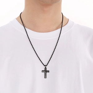 Close-up of a man wearing a sleek black stainless steel cross pendant on a twist chain