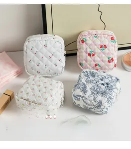 Detailed view of quilted cotton pouches featuring various floral and cherry patterns