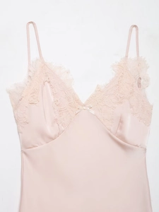 Détail d'une robe nuisette en satin rose avec dentelle délicate et col en V chic