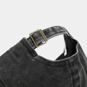 Detail of vintage metal adjustment buckle on high-quality corduroy baseball cap