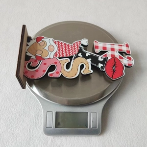 Detail view of Valentine wooden gnome sign on an electronic scale showing 30.9g weight