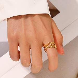 Fashionable golden stainless steel open heart ring for women on a model's finger