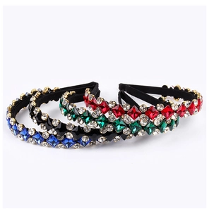 Detailed view of colorful crystal rhinestones on padded headbands in multiple colors