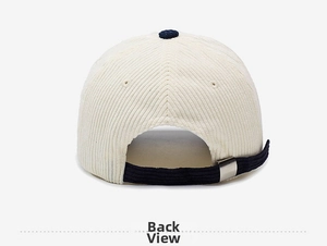 Detail of adjustable metal buckle and navy strap on cream corduroy baseball cap