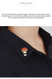 Detail of coffee cup brooch with red roses and gold enamel trim on a denim jacket