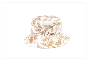 Detailed view of vintage floral and bird print on white silk-like bucket hat