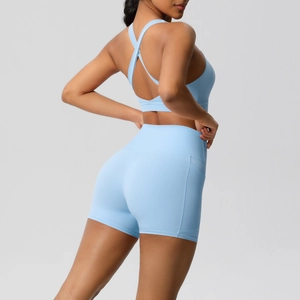 Detail of light blue high waist shorts with side pocket and cross back sports bra set