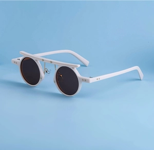 White round sunglasses featuring a flat top bar with gold star accents and brown lenses