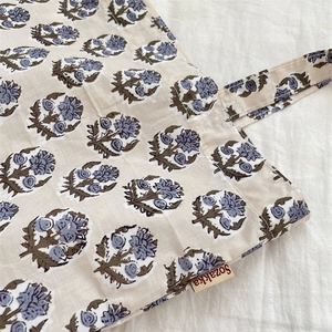 Detailed close-up of vintage floral canvas tote featuring blue woodblock print patterns