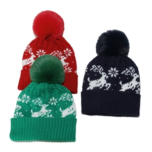 Three Christmas beanies with reindeer patterns, snowflakes, and faux fur pom-poms