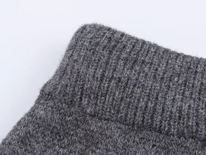 Macro shot of high-quality dark grey ribbed knit fabric texture with soft wool fibers
