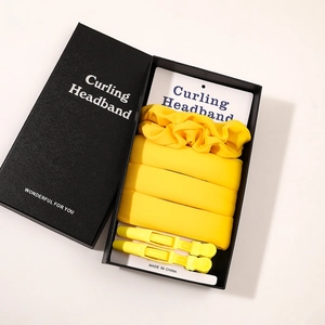 Detailed set of bright yellow satin heatless hair curlers with clips in a premium gift box