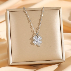 Exquisite silver clover necklace with zircon pendant on elegant champagne jewelry box