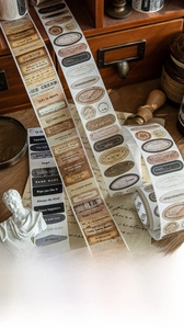 Detail of vintage die-cut washi tape featuring English phrases and retro stamp designs
