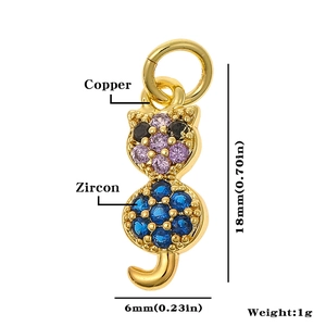 Macro view of gold cat pendant made of copper and zircon with dimensions 18mm by 6mm