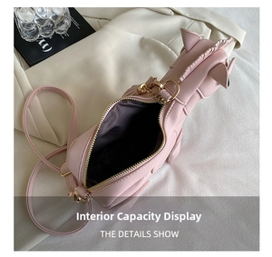 Detail showing internal capacity and grey fabric lining of pink unicorn crossbody bag