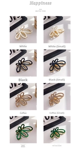 Detail of flower hair clips in four colors and two sizes with metal frames