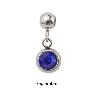 Macro shot of a silver September birthstone pendant with a blue sapphire crystal detail