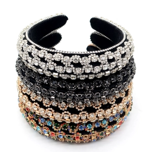 Close-up of sparkling rhinestone headbands on velvet padding in multiple color options
