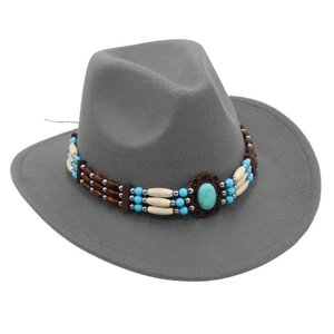 Detail of western fedora hat featuring turquoise gemstone and ethnic beaded band trim
