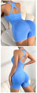 Detail of blue yoga bodysuit featuring cross straps and ribbed tummy control texture