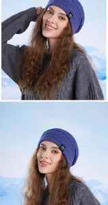 Close-up of winter cable knit beanie featuring a branded label against a snowy mountain backdrop