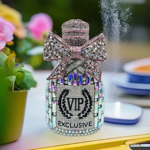 Macro shot of luxury crystal bottle clutch with pink bow and sparkling VIP diamond pattern