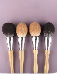 Detailed view of 4-piece makeup brush set with gradient bristles and wood handles