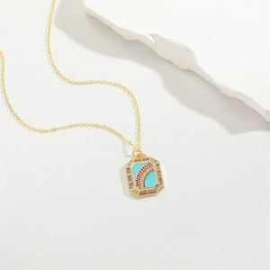 Chic gold chain necklace with rainbow pendant and purple zirconia on cream background