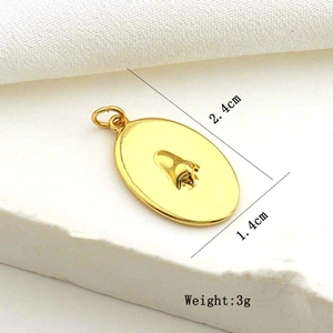 Macro detail of a gold oval pendant with dimensions 2.4cm by 1.4cm and 3g weight