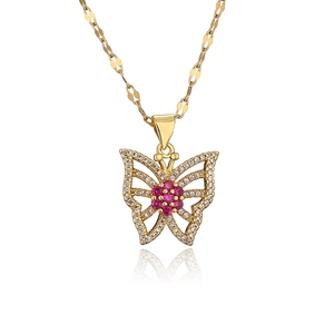Gold plated butterfly necklace with pink gemstone and zircons on white background