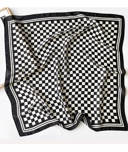 Detailed view of the checkered silk scarf texture with black and white grid patterns