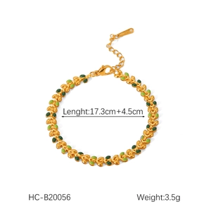 Detail of 18K gold stainless steel leaf bracelet with green enamel and size markings
