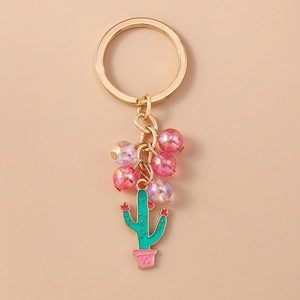 Close-up of beaded cactus keychain with pink translucent beads and golden metal ring