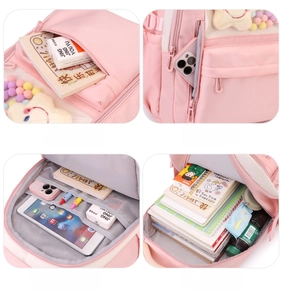 Detailed interior storage compartments of pink nylon school backpack with multiple pockets