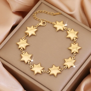 Golden star stainless steel chain bracelet displayed on a premium silk background