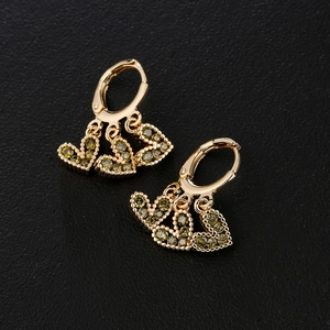 18K gold plated hoop earrings with three dangling green zircon heart charms on black background