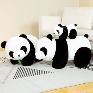 Three cute stuffed panda plush toys in different sizes resting on a patterned carpet