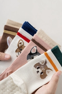 Detail of knit cotton five-toe yoga socks with cute animal faces and non-slip dots