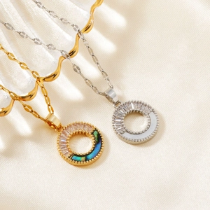 Detail of gold and silver circle necklaces with rectangular zircon and shell inlays